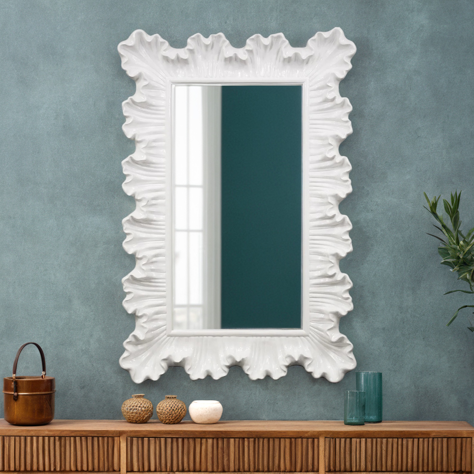 white_ruffle-Living Room And Family Room Wall Mounted Mirrors Bohemian 3 A white mirror mounted on a wall above a console table reflects the living room scene